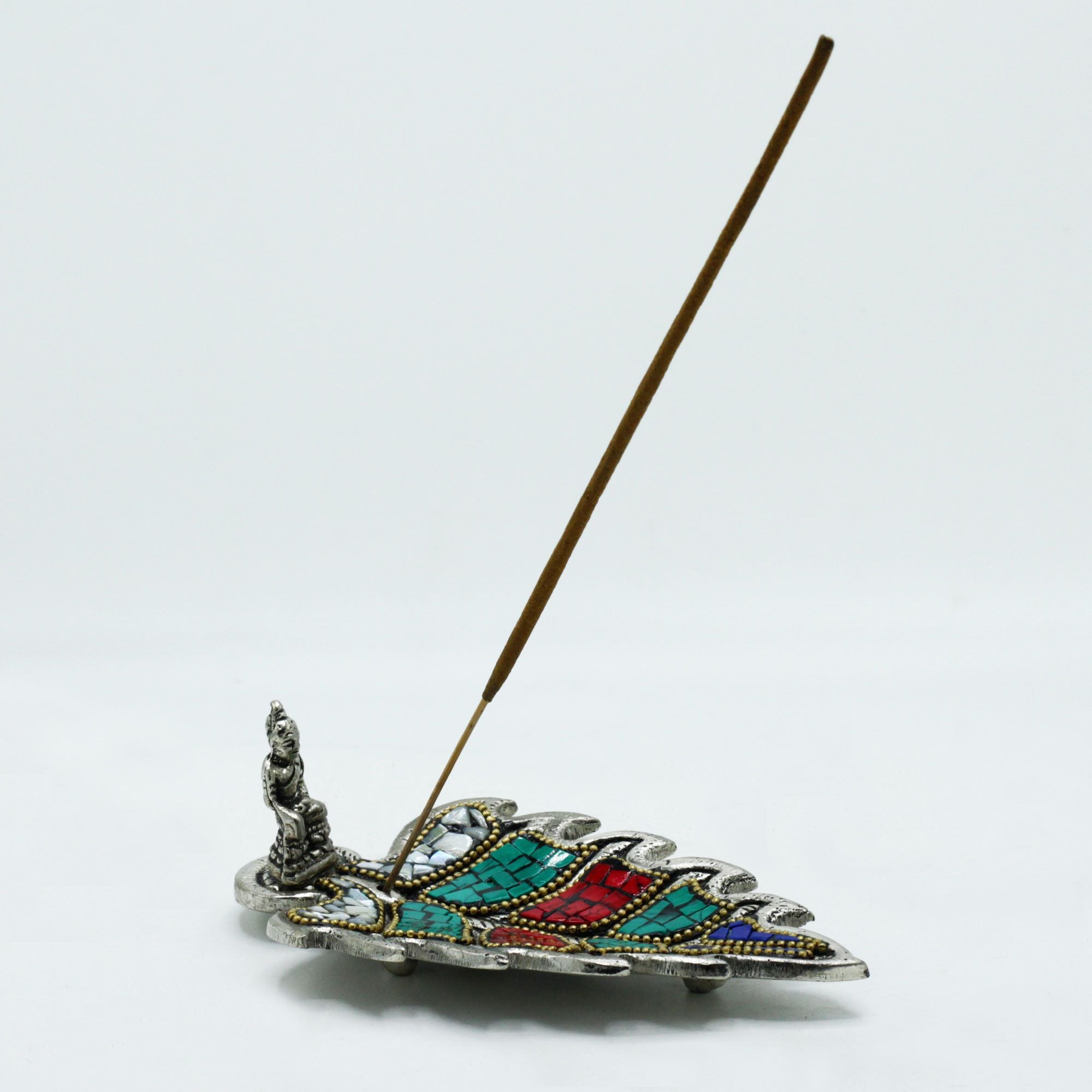 Decorative incense holder with colorful design on a white background