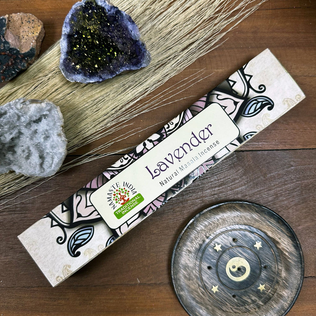 Lavender incense packaging on a wooden surface with decorative elements