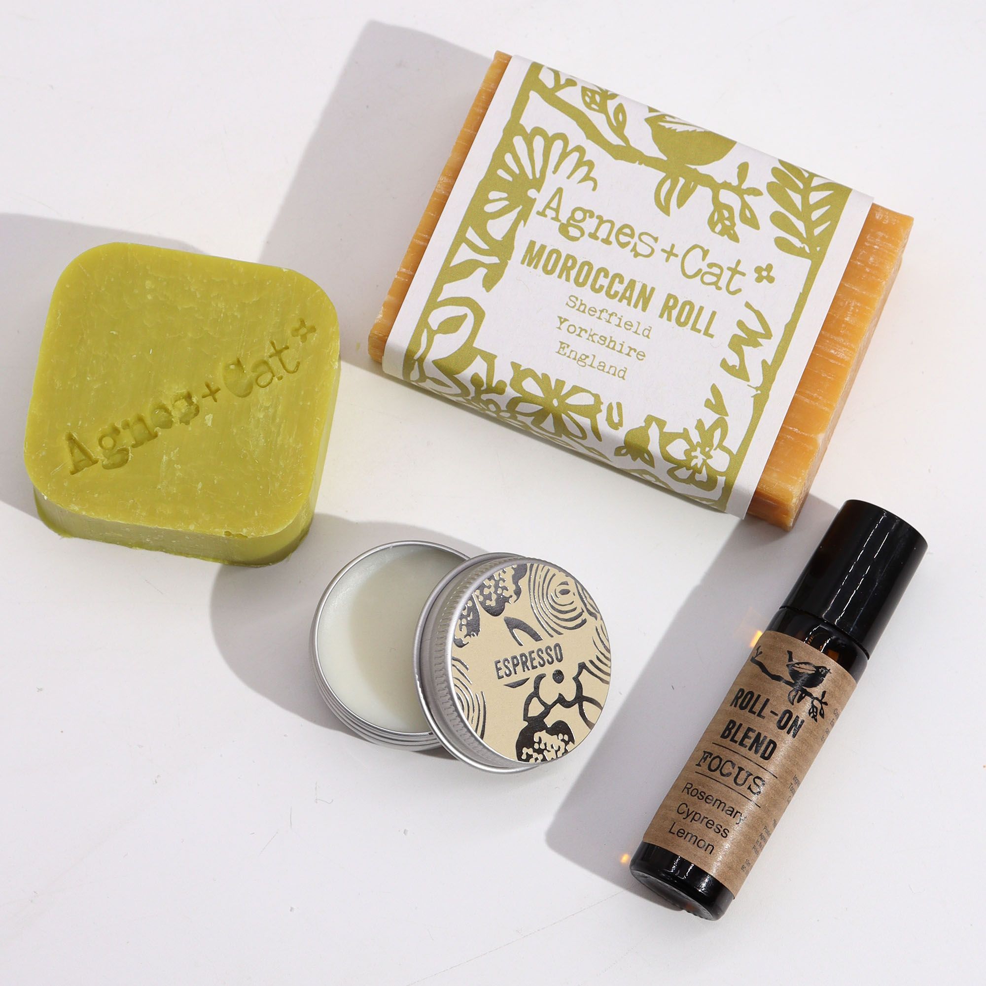 Collection of Agnes + Cat products including soap, candle, and roll-on blend on a white background