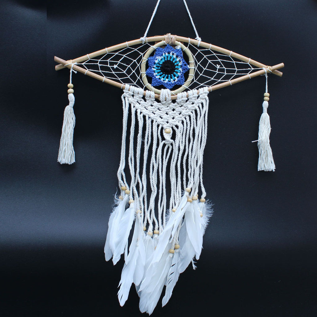 Dreamcatcher with feathers and beads on a dark background