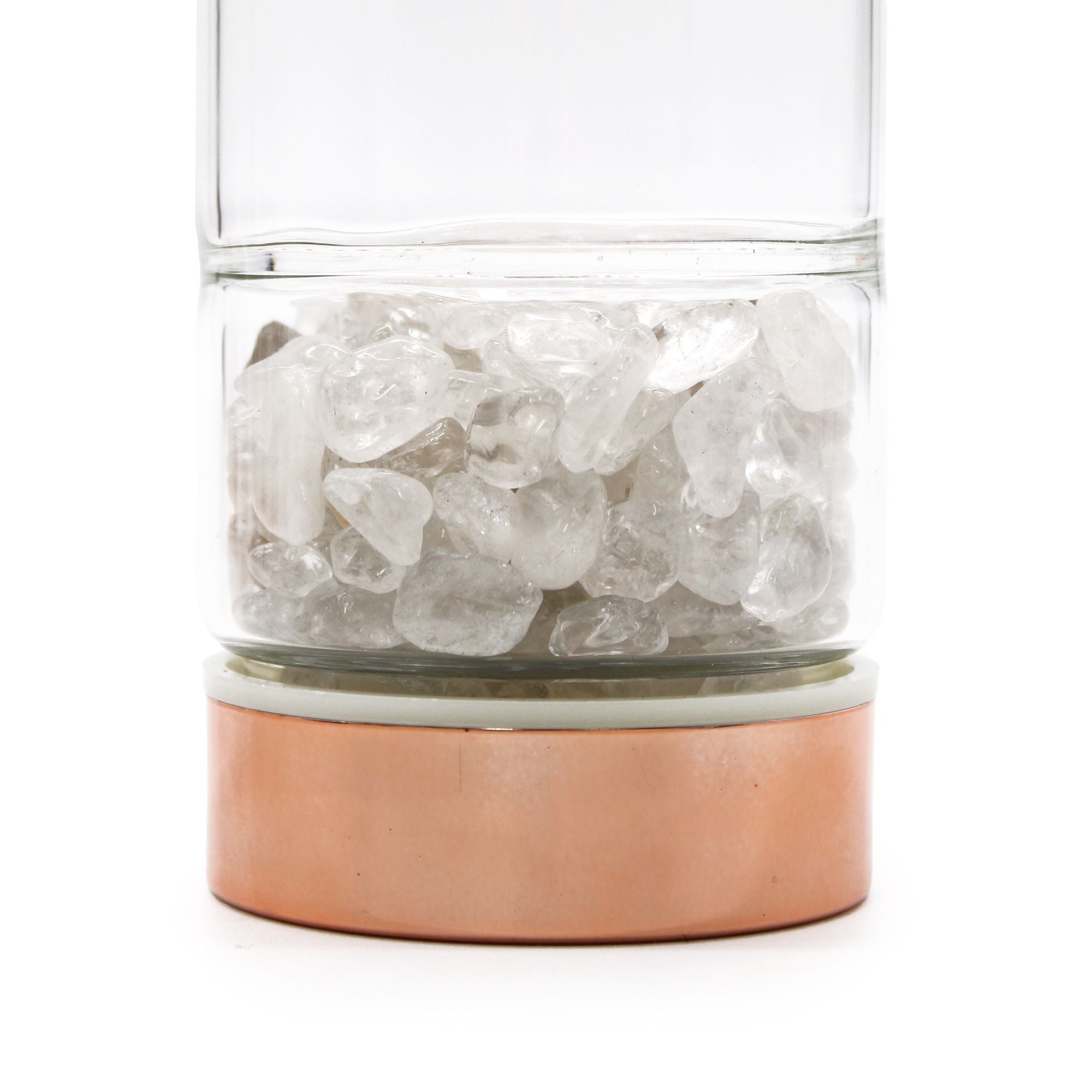 Clear glass container with copper base filled with ice cubes on a white background