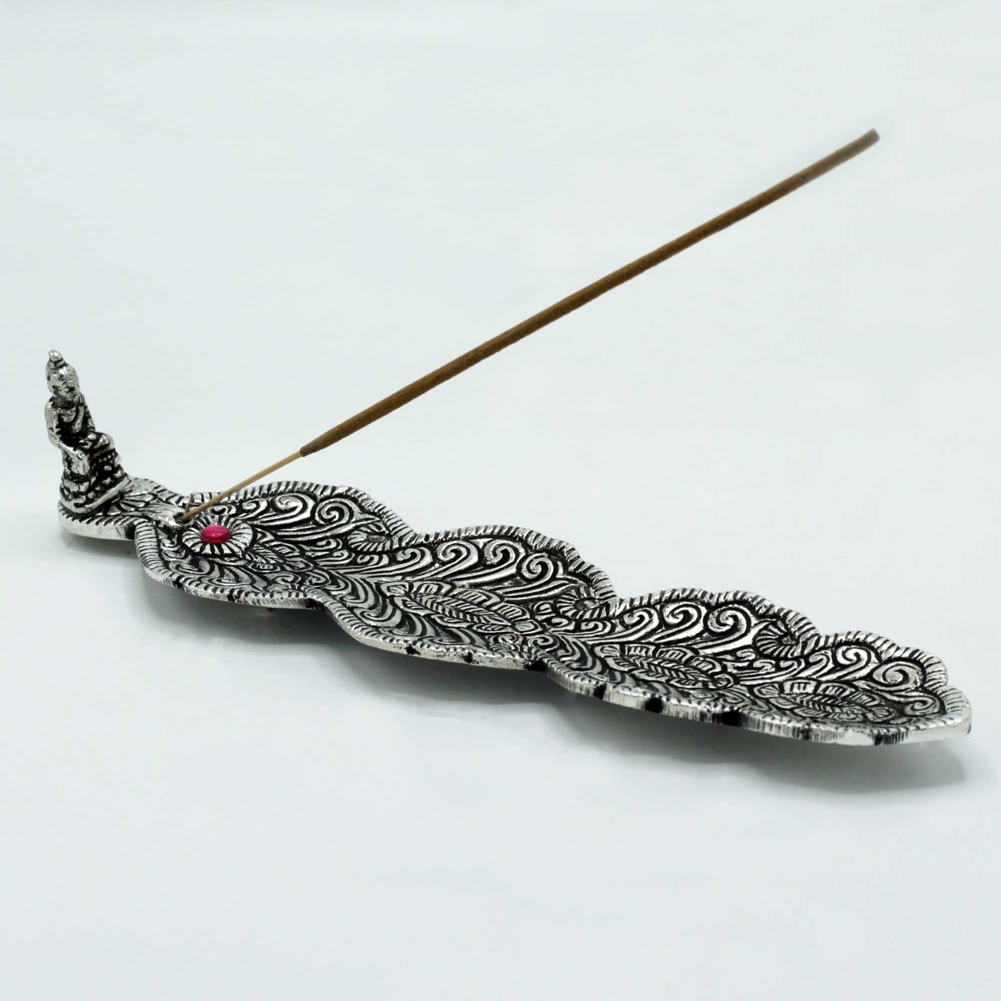 Decorative incense holder with intricate patterns on a white background