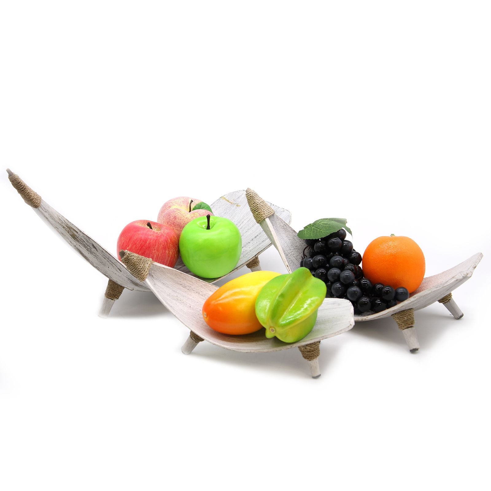 Fruit display on a decorative stand with apples, oranges, and grapes.