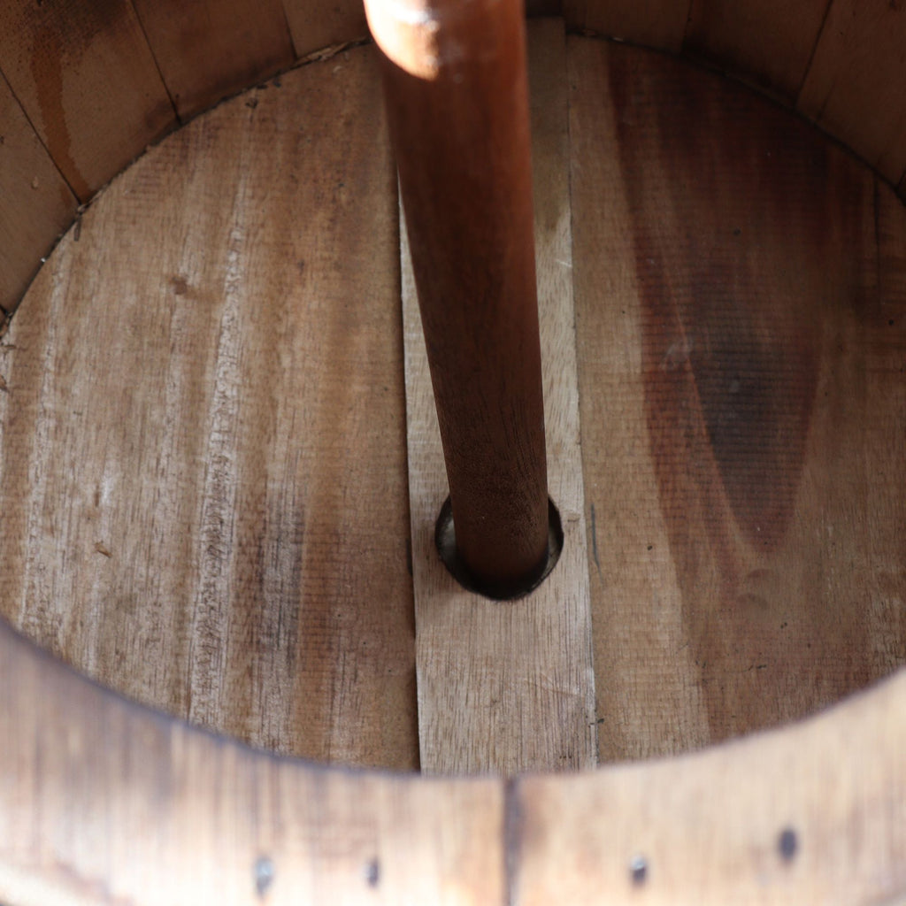 Close-up of a wooden barrel with a metal valve