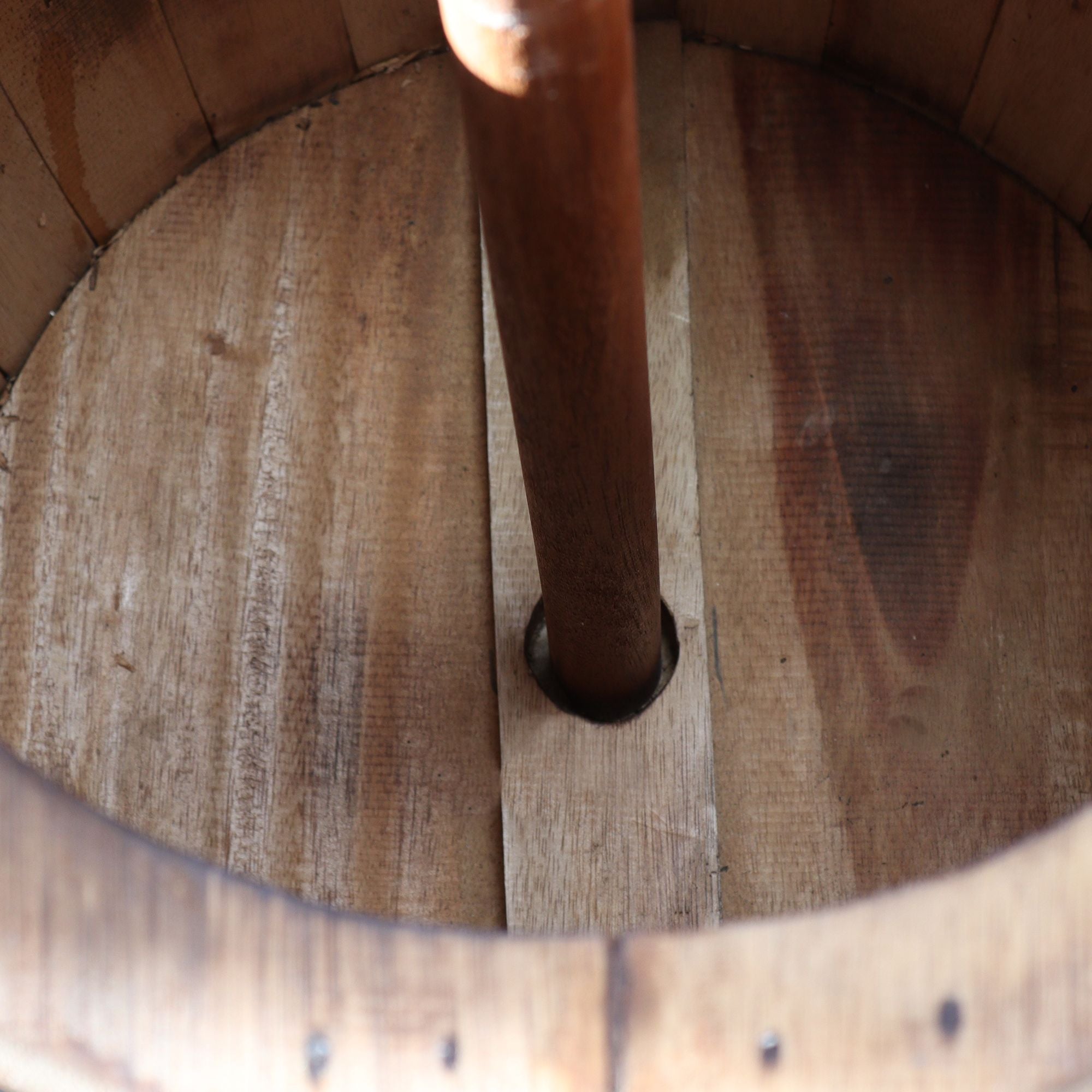 Close-up of a wooden barrel with a metal valve