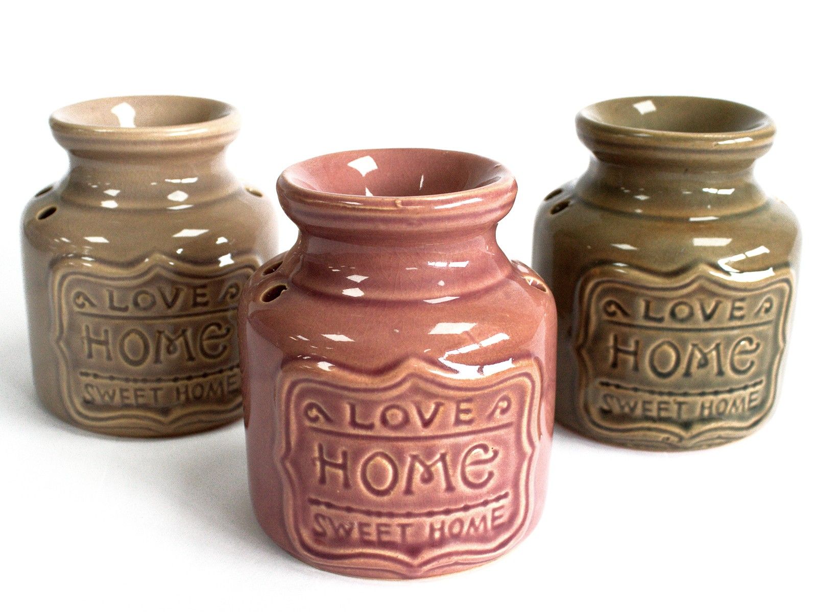 Three ceramic jars with 'Love Home Sweet Home' text on a white background