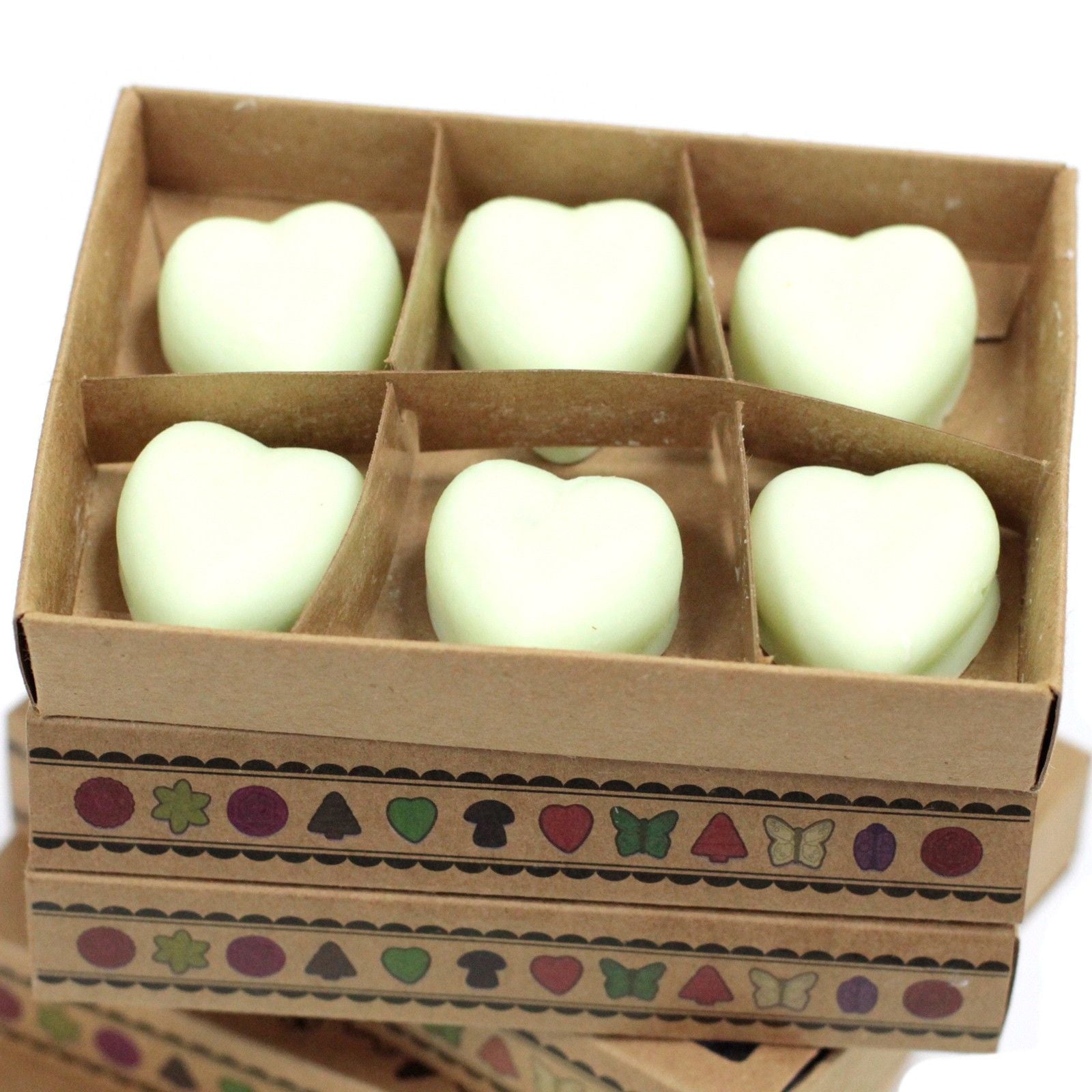 Heart-shaped objects in a cardboard box with decorative patterns on a white background