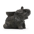 Decorative elephant figurine with intricate designs on a white background