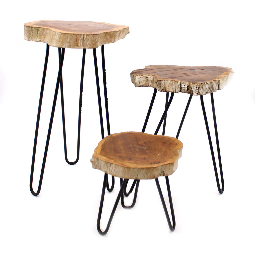 Set of three wooden side tables with black metal legs on a white background
