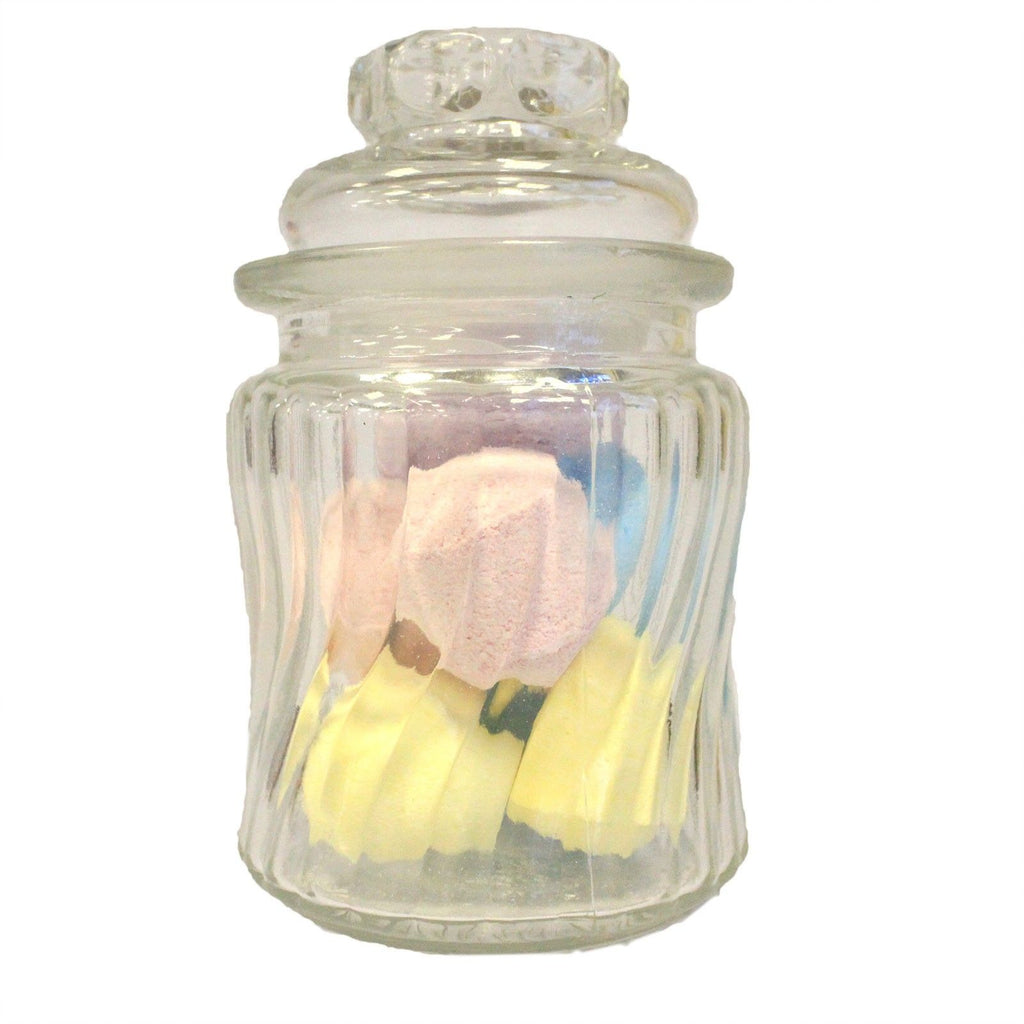 Glass jar with a small plush toy and yellow flowers on a white background