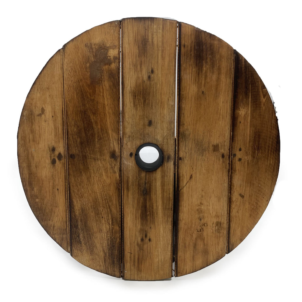Wooden spool with a central hole on a white background