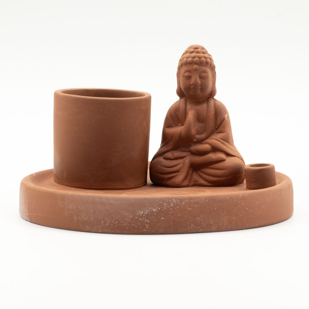 Terracotta Buddha figurine with a cylindrical container on a white background