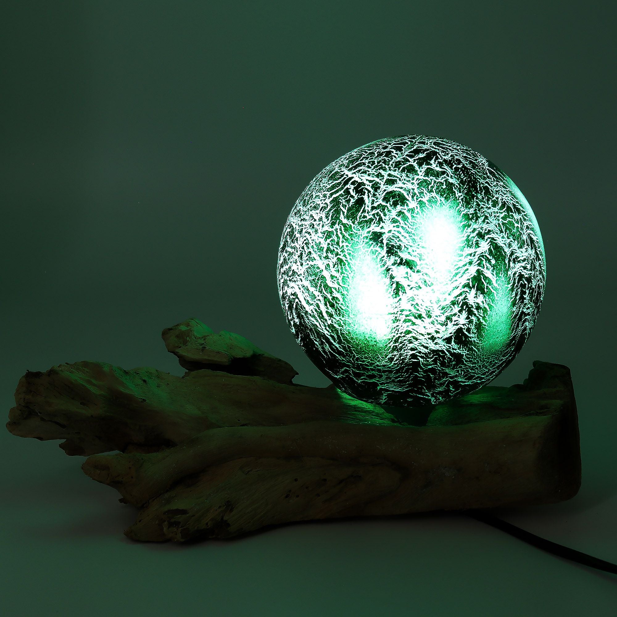 Glowing green crystal ball on a dark background