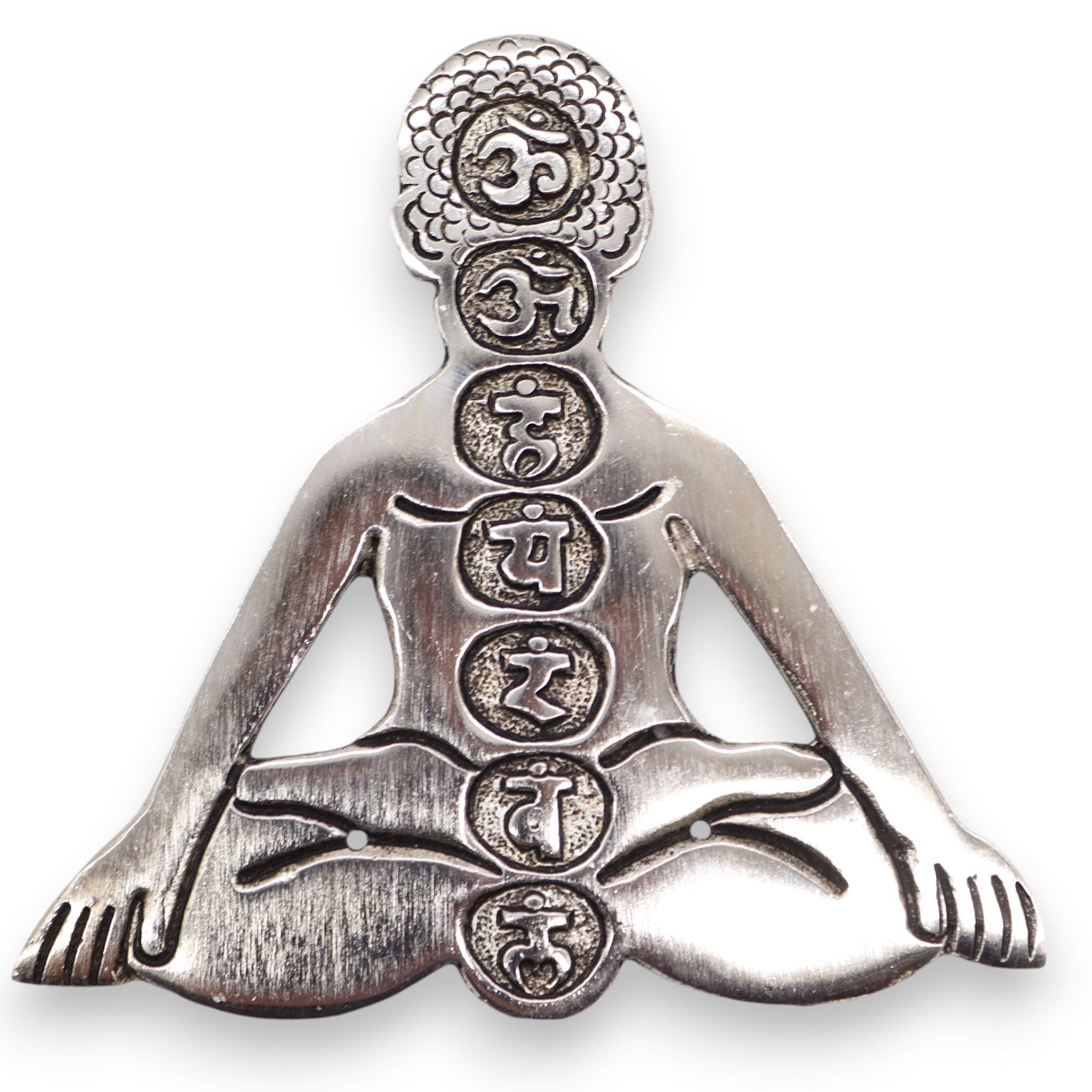 Silver pendant of a meditating figure with symbols on a white background