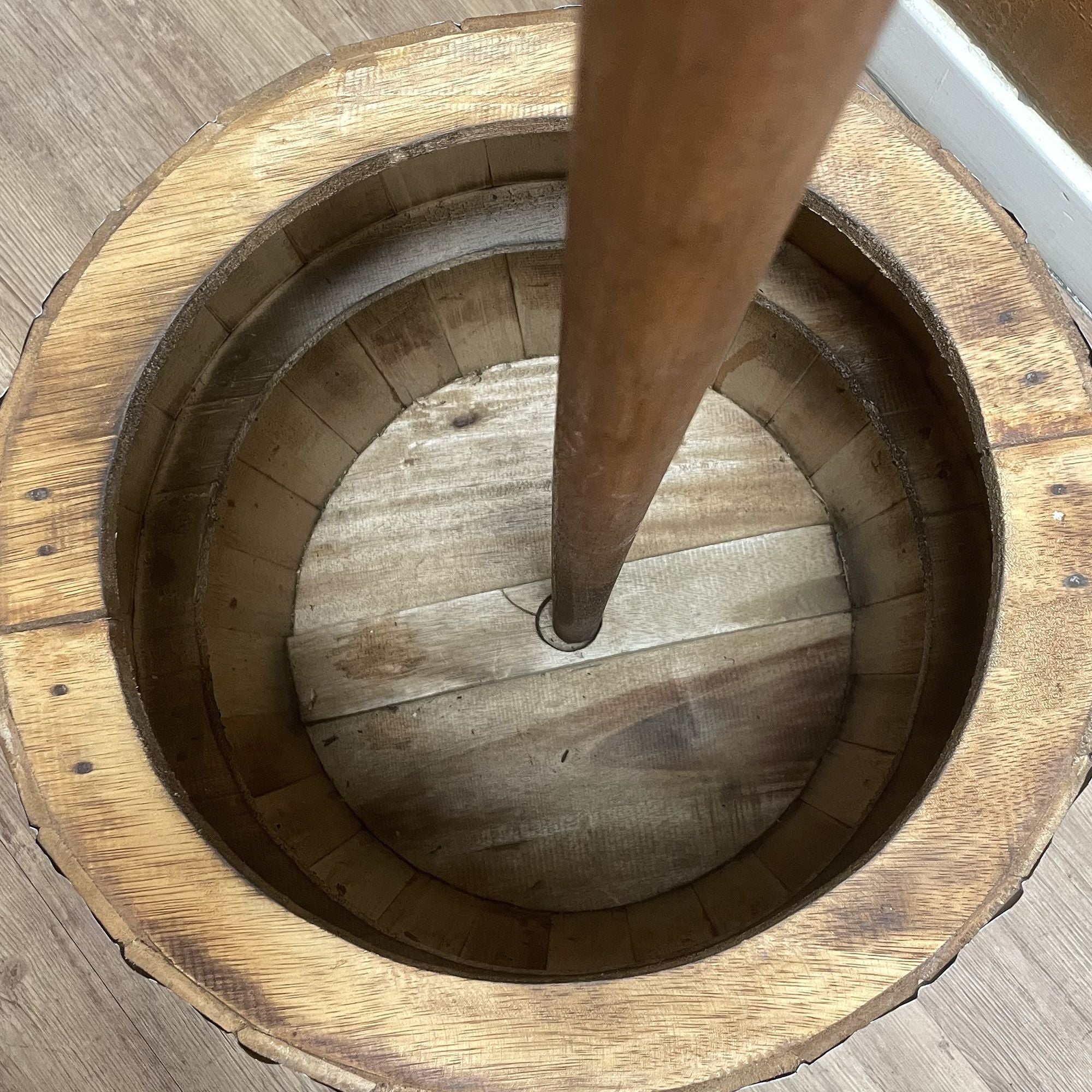 Wooden barrel with a wooden leg inside on a wooden floor