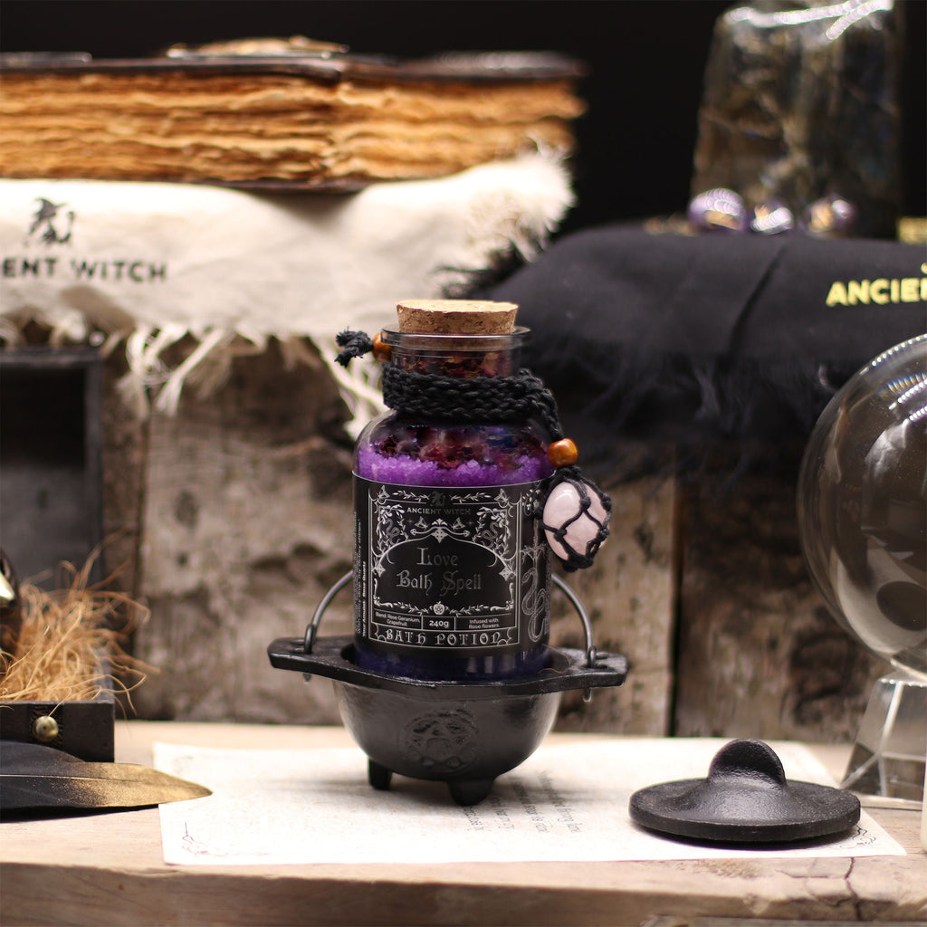 Decorative candle holder with a purple candle on a table with a mystical background.