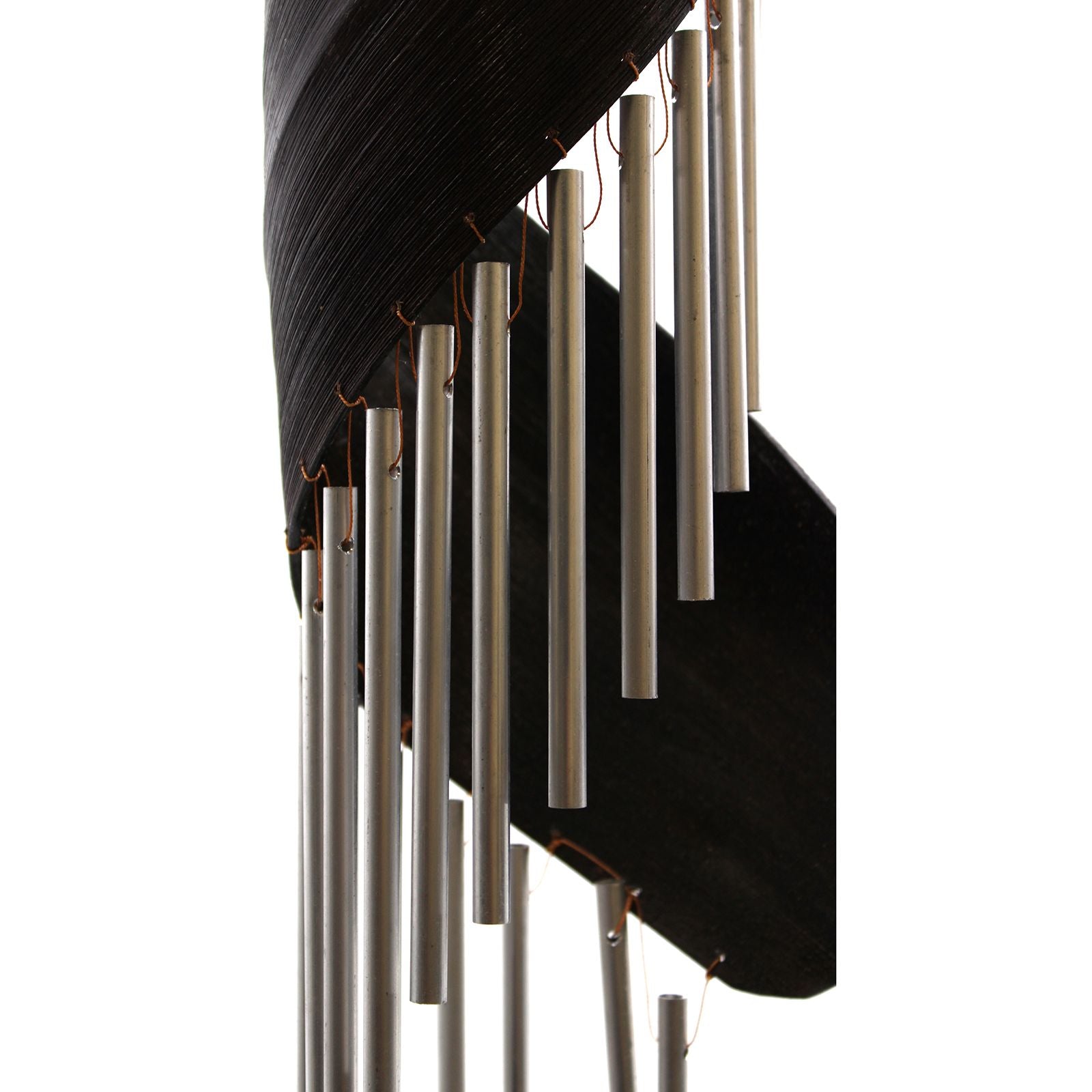 Close-up of a wind chime with metallic tubes on a white background