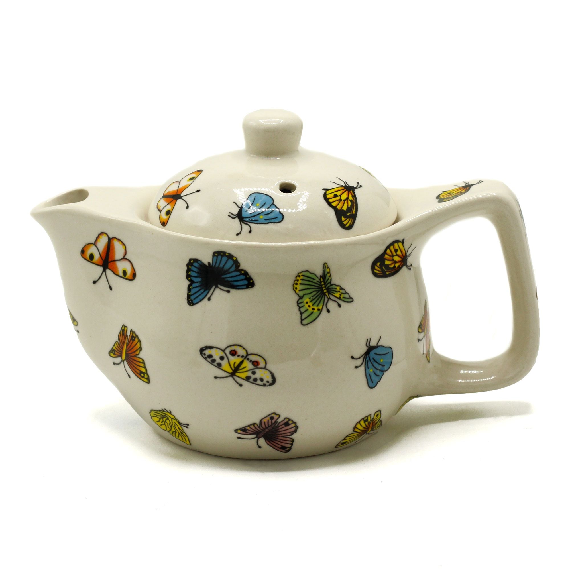 Ceramic teapot with butterfly designs on a white background