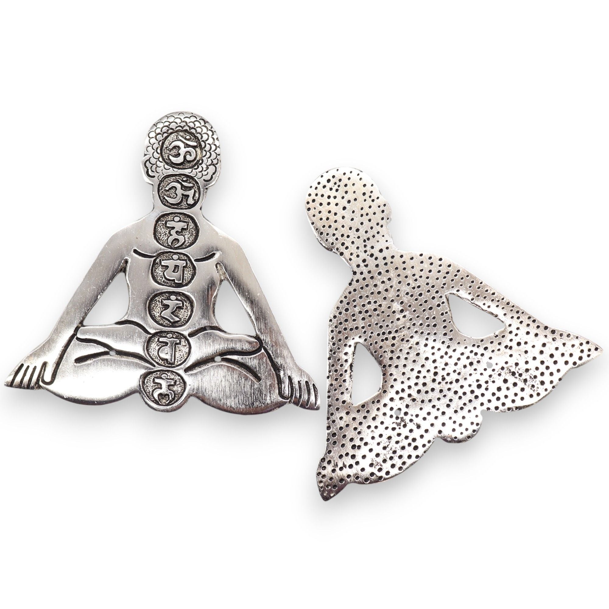 Silver pendant of a meditating figure with symbols on a white background