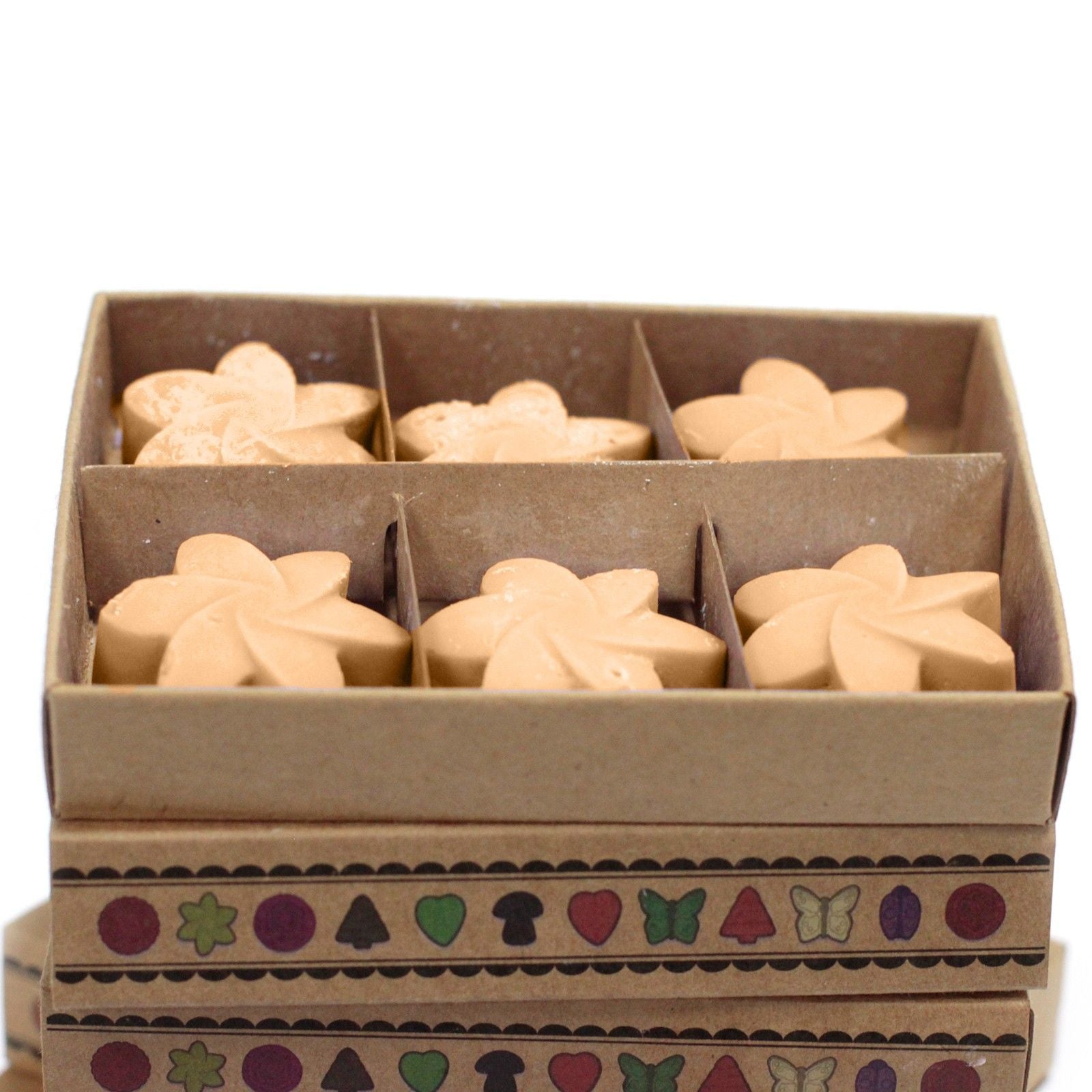 Box of star-shaped cookies with a decorative box lid on a white background