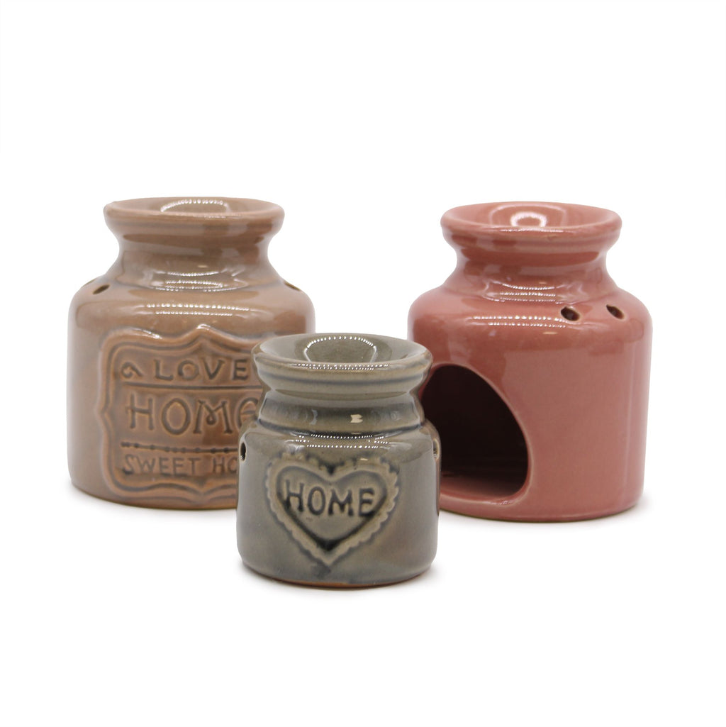 Three ceramic jars with 'HOME' and heart designs on a white background