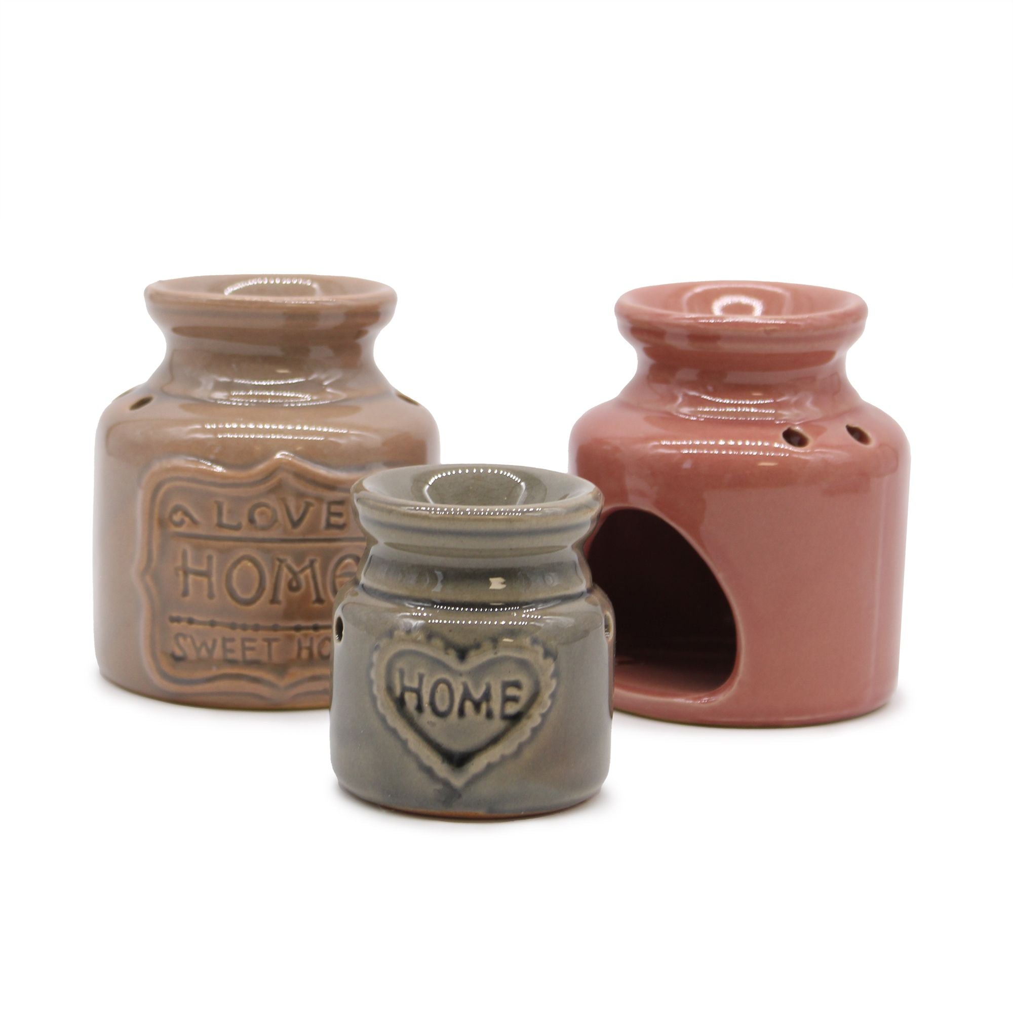 Three ceramic jars with 'HOME' and heart designs on a white background