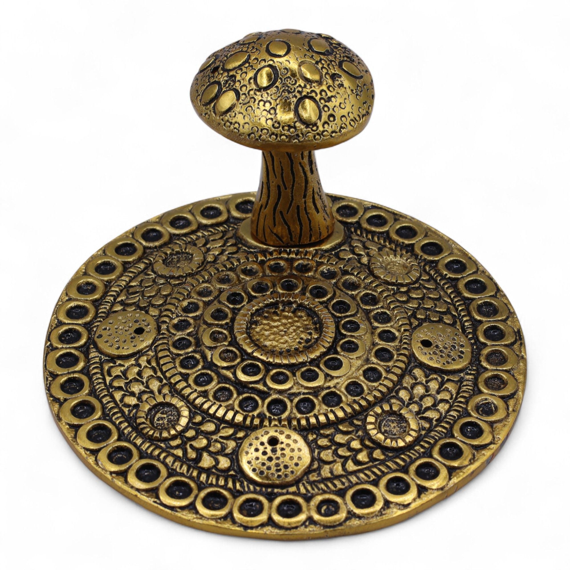 Decorative brass object with intricate patterns on a white background