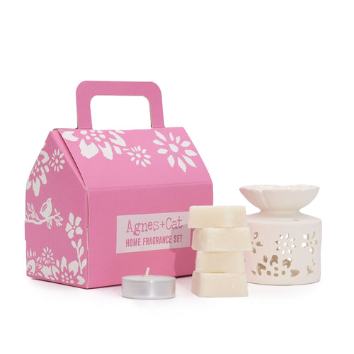 Pink gift box with 'Agnes + Cat' branding, featuring candles and a lantern on a white background.