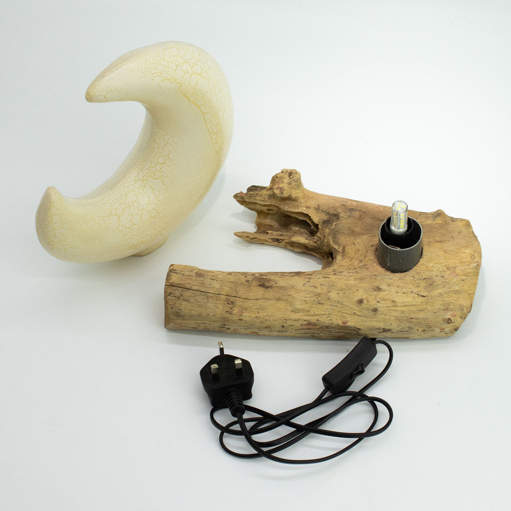 Wooden lamp with natural finish and black cord on a white background