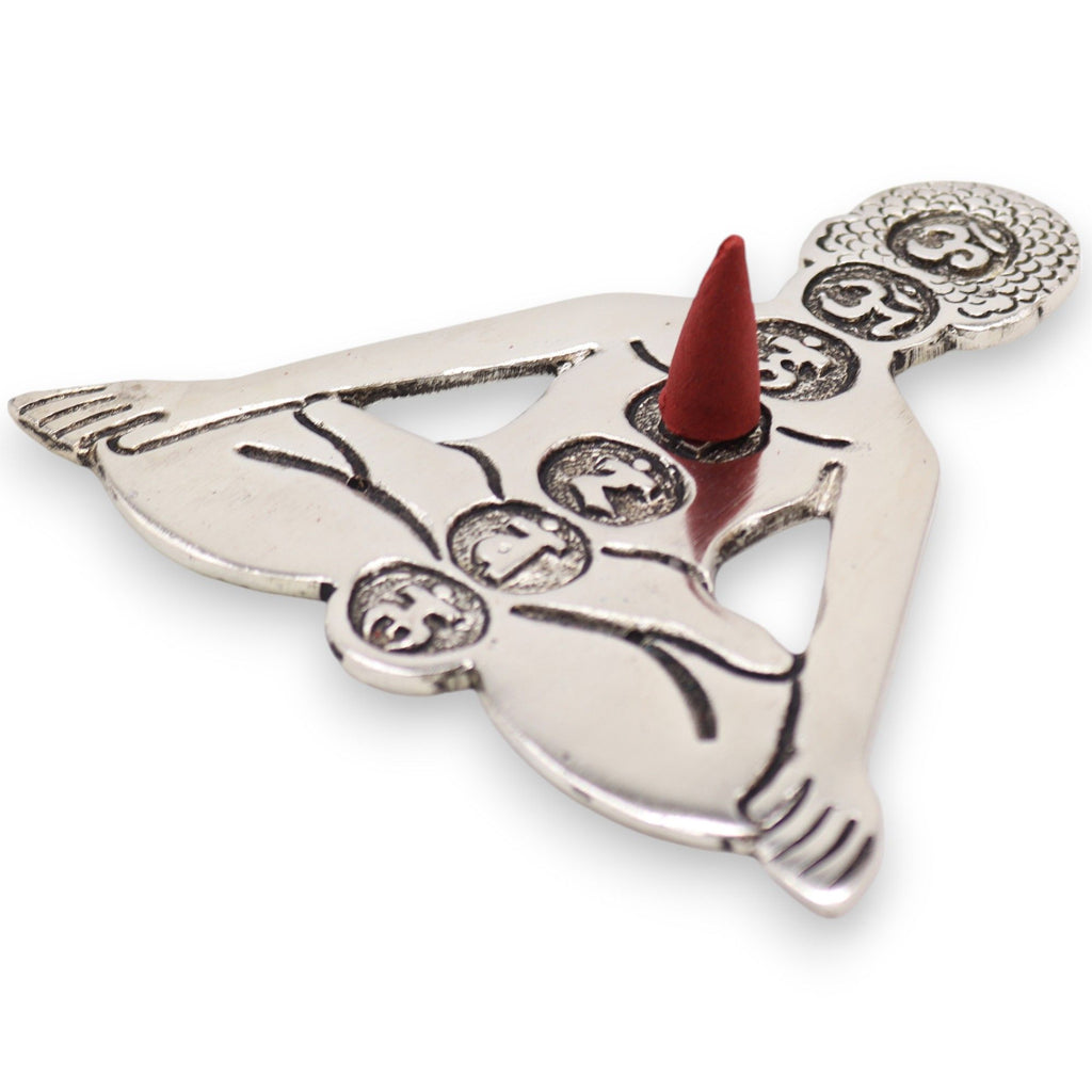 Decorative metal incense holder with a red cone on a white background