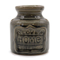 Ceramic jar with 'Love Home Sweet Home' text on a white background