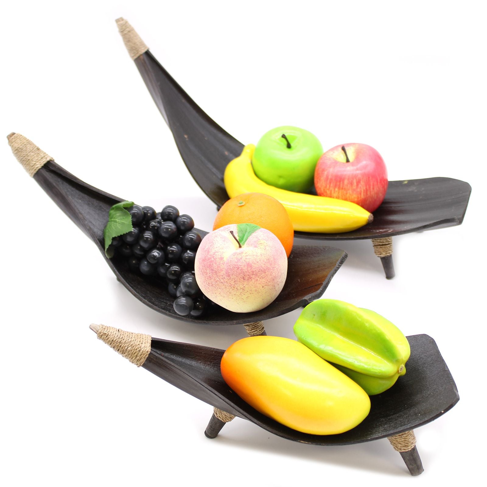 Fruit display set with black leaf-shaped bowls on a white background