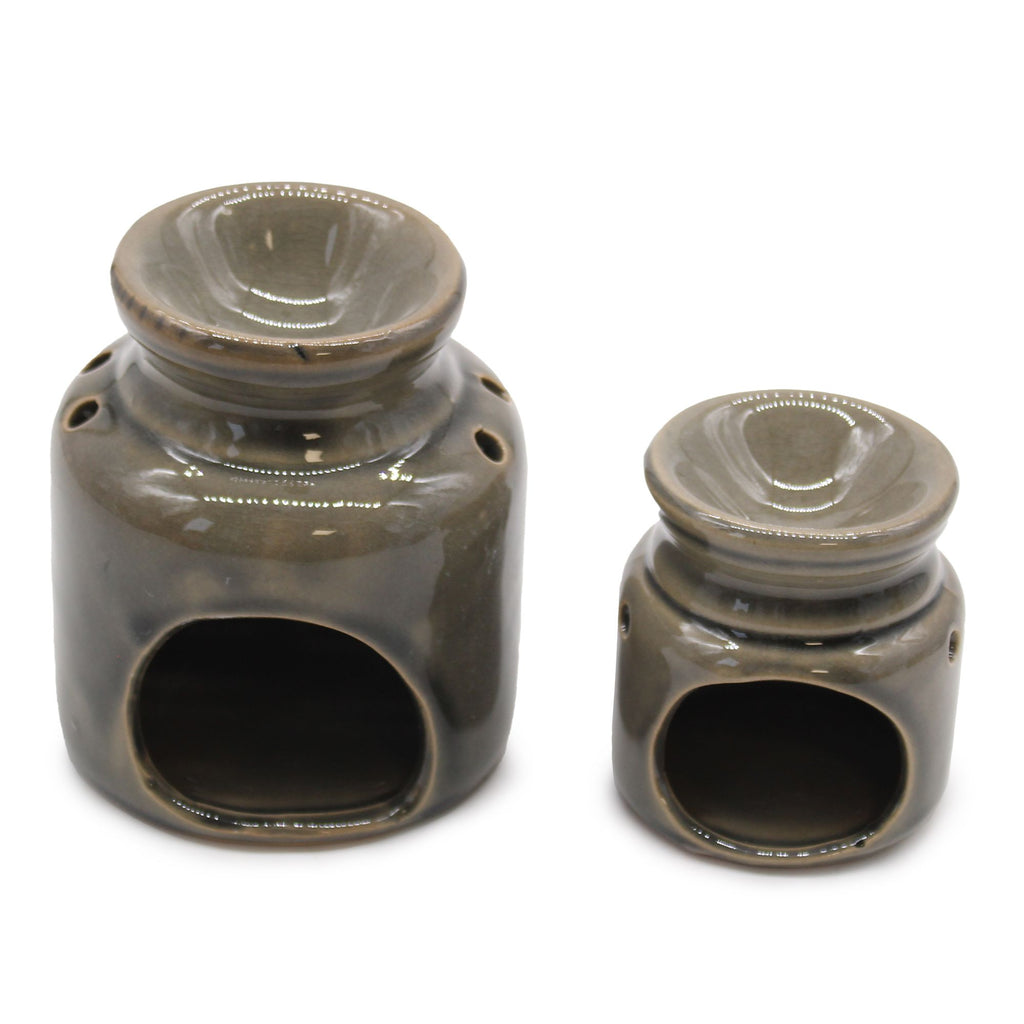 Two ceramic oil burners with a brown glaze on a white background