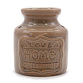 Brown ceramic jar with 'Love Home Sweet Home' text on a white background