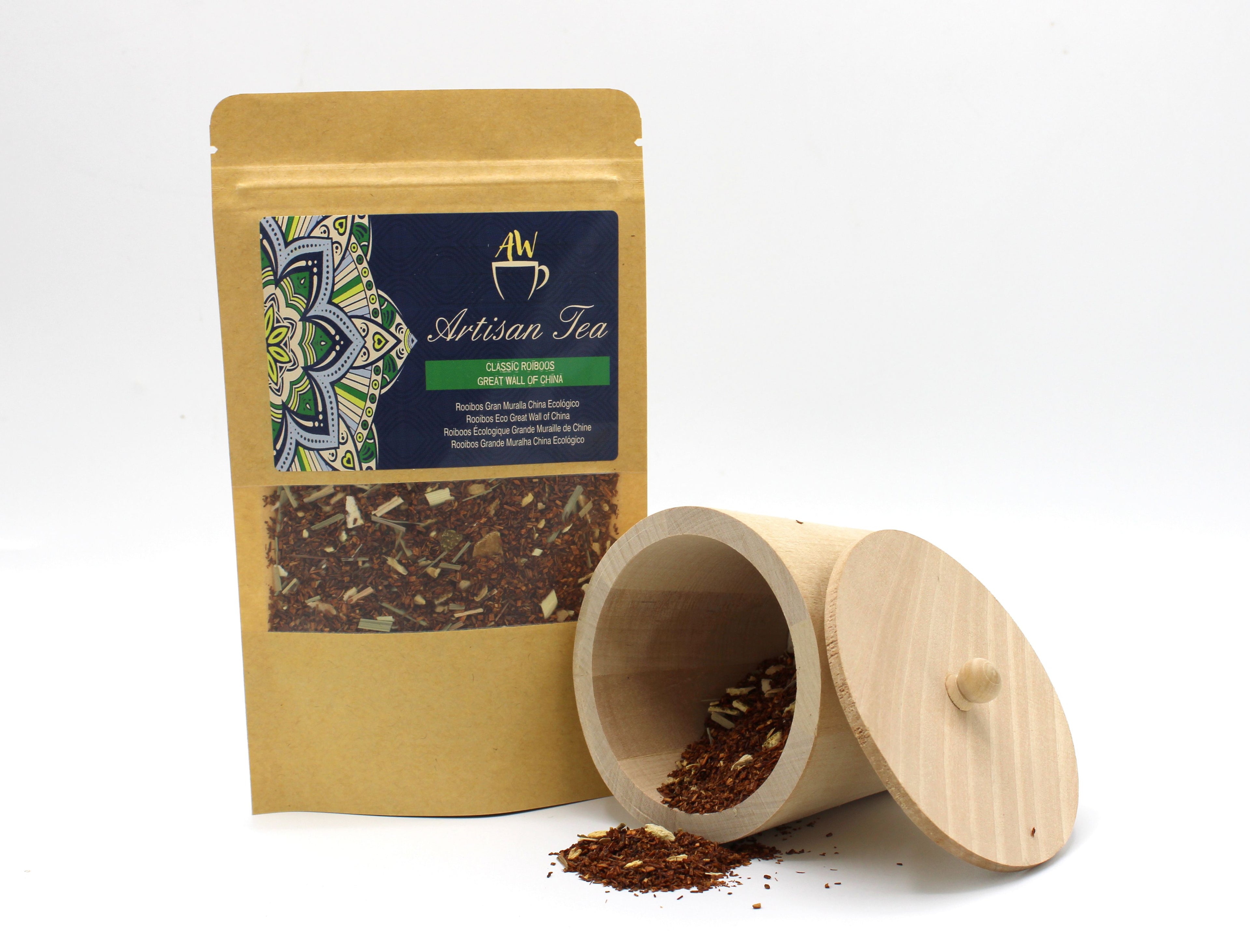 Artisan tea package with a wooden scoop containing tea leaves on a white background