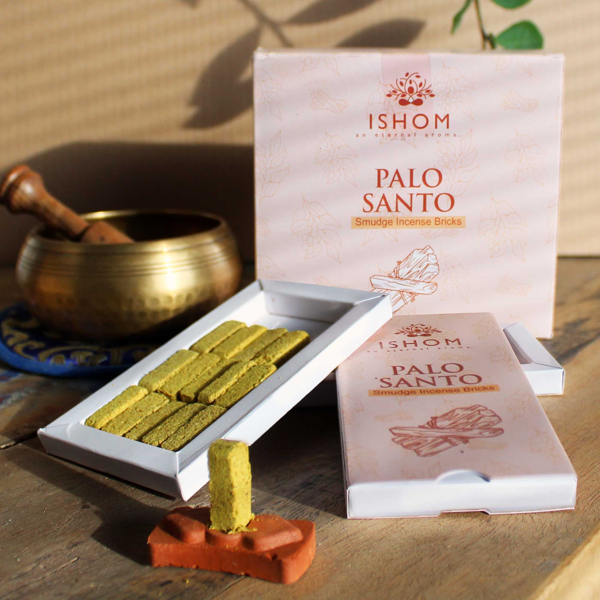 Ishom Palo Santo incense sticks with packaging on a wooden surface