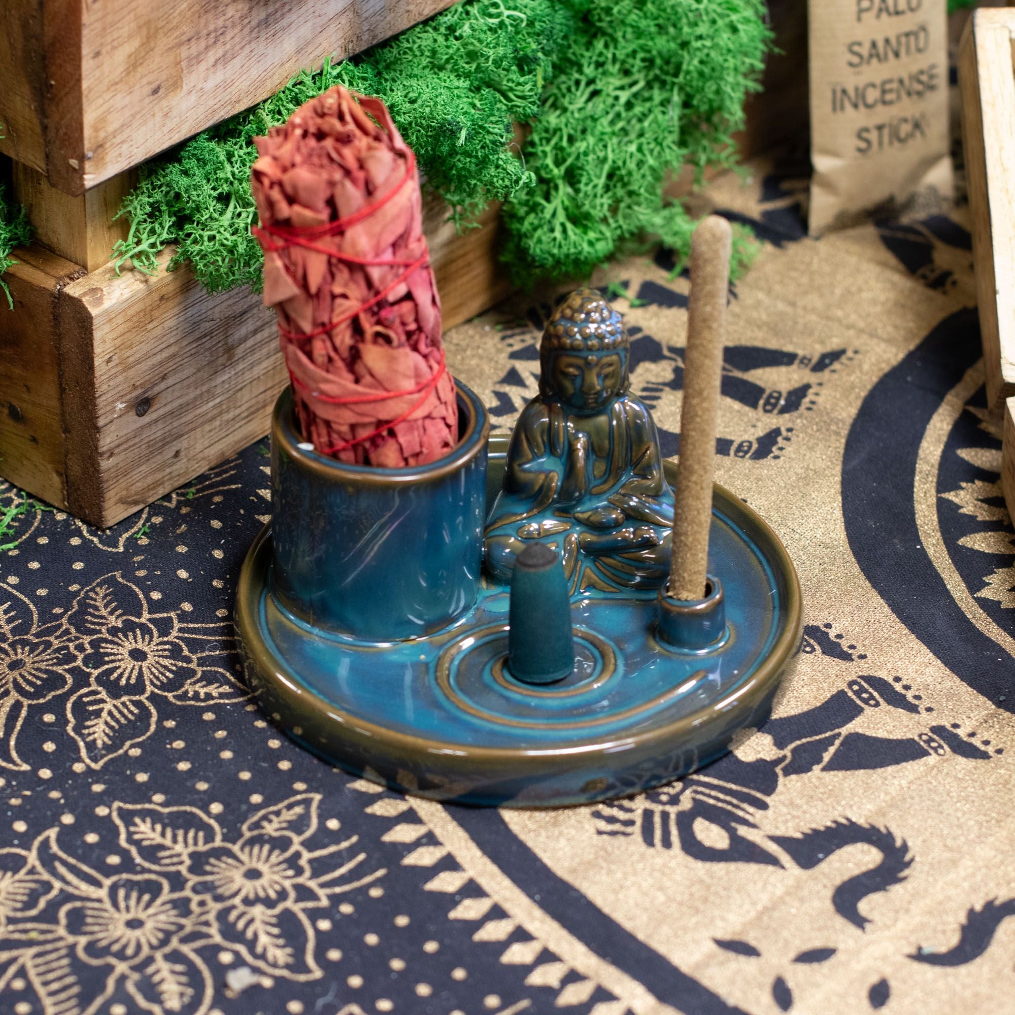 Incense holder with incense sticks on a patterned surface