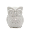 White ceramic owl-shaped night light on a white background