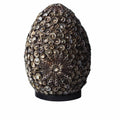 Decorative object with shell-like patterns on a white background
