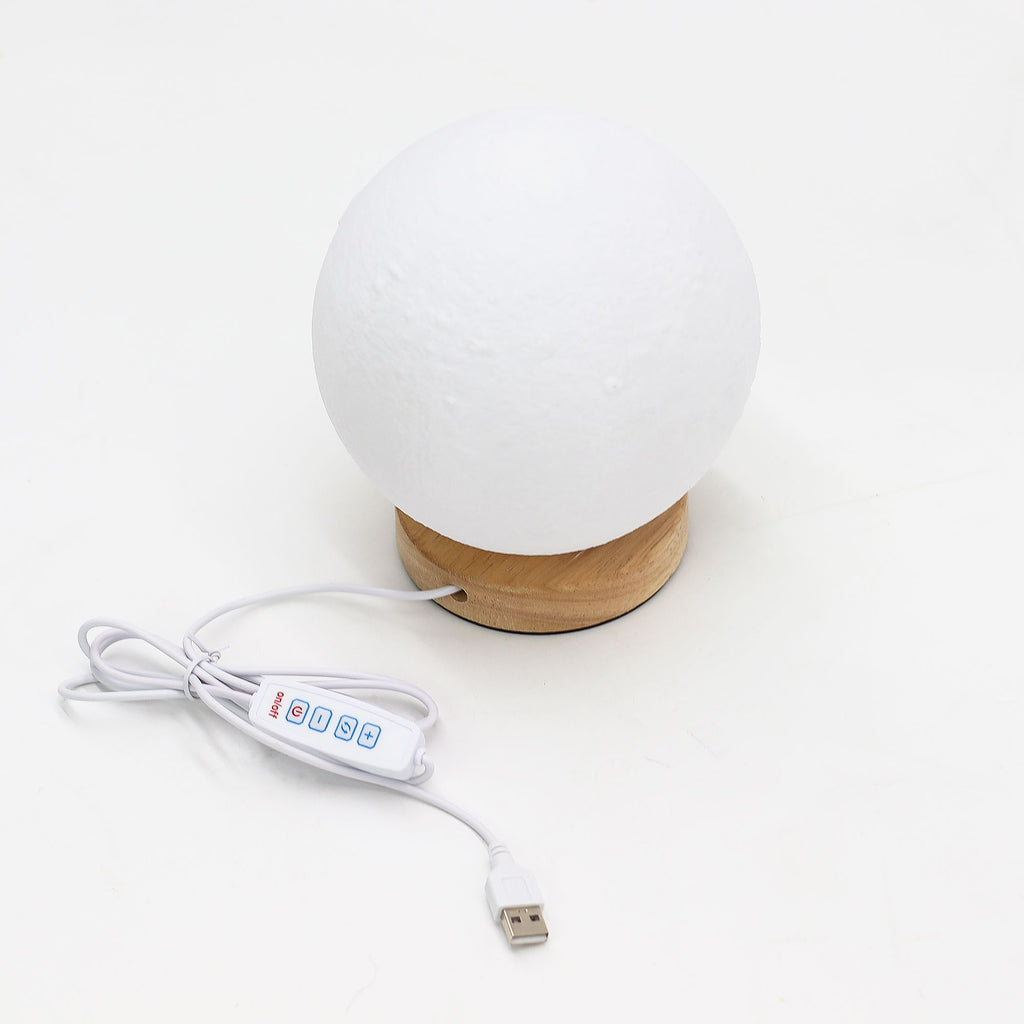 White spherical lamp with wooden base and USB cable on a white background