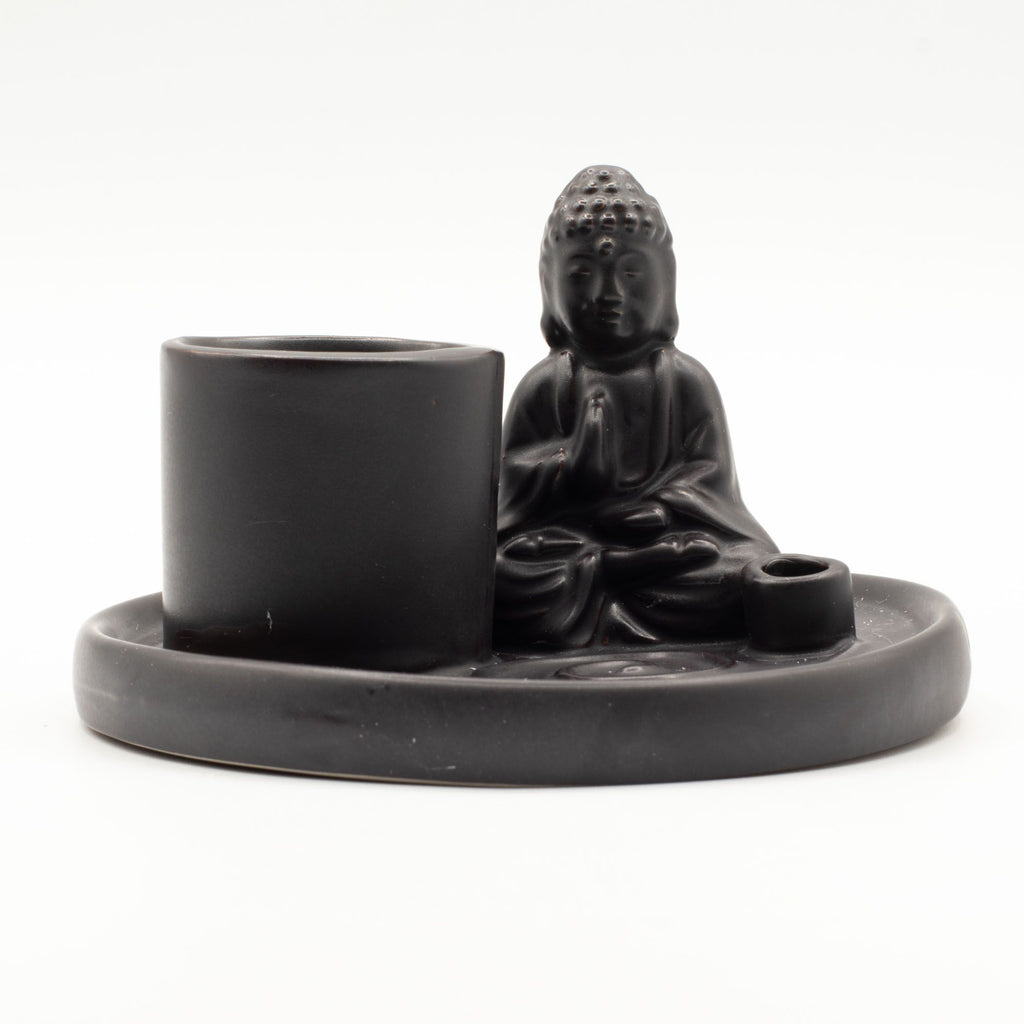 Black ceramic Buddha figure with a cup and small bowl on a matching tray against a white background