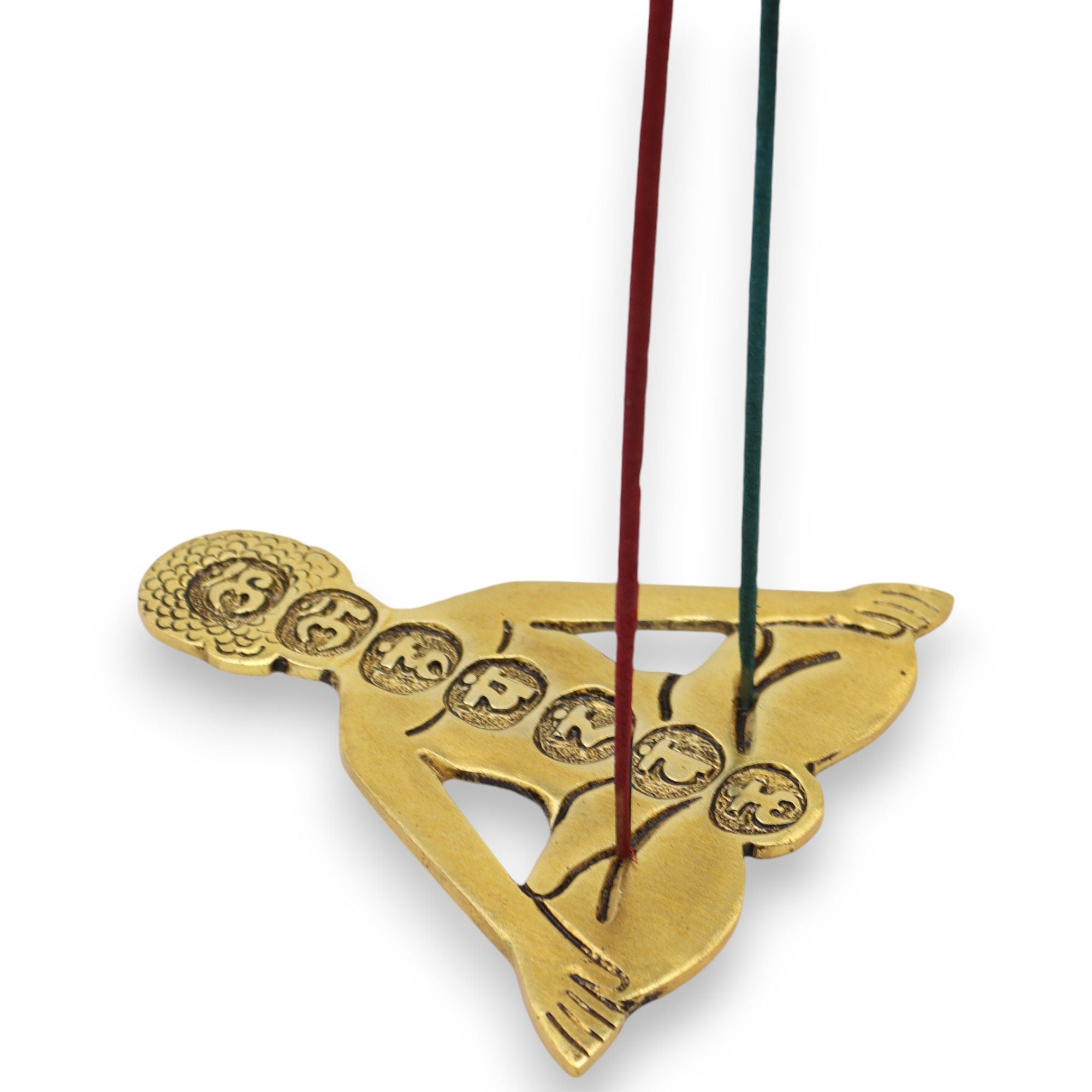 Gold incense burner shaped like a butterfly with incense sticks on a white background