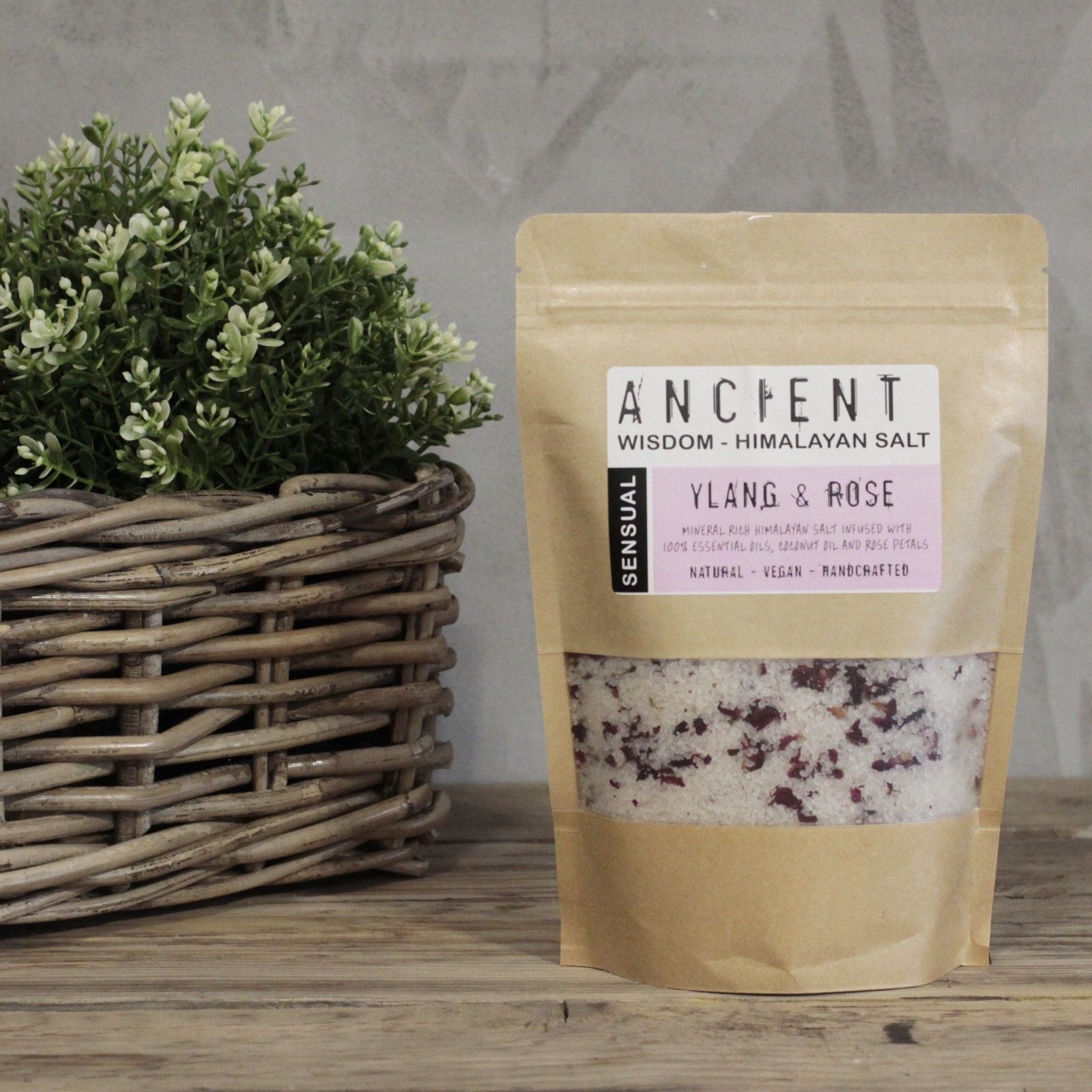 Himalayan salt packaging labeled 'Ancient Wisdom' with a plant in the background