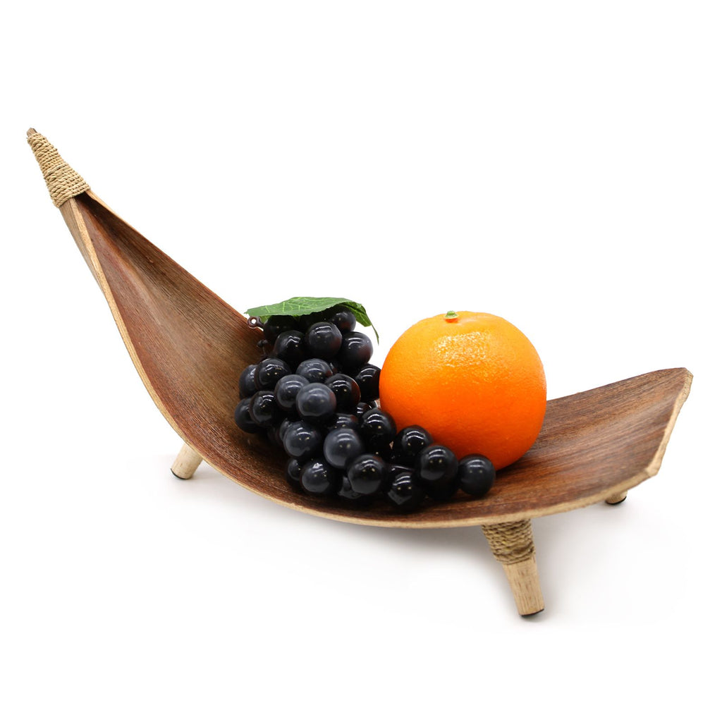 Wooden fruit hammock with grapes and an orange on a white background