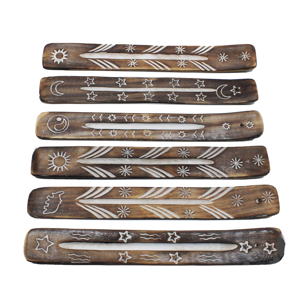 Set of six wooden incense sticks with engraved designs on a white background