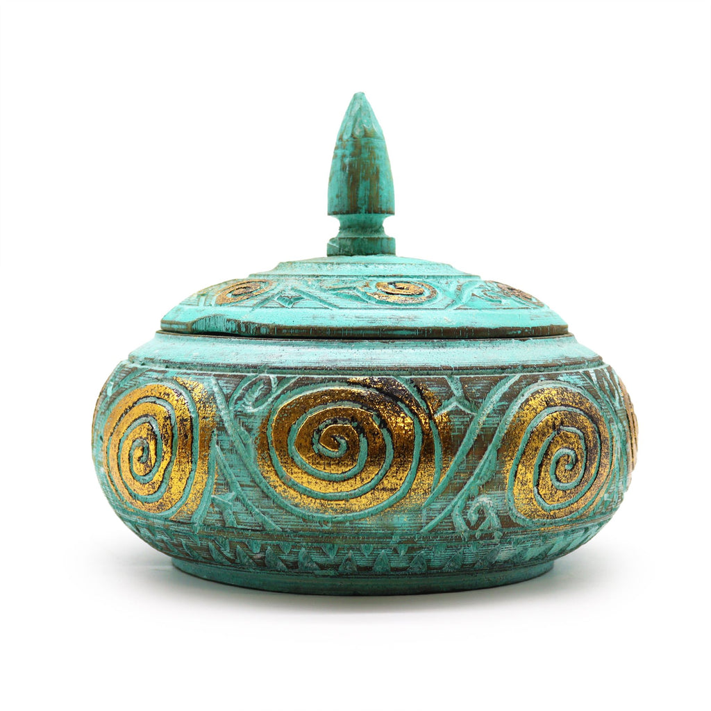 Decorative turquoise pot with gold spiral patterns on a white background