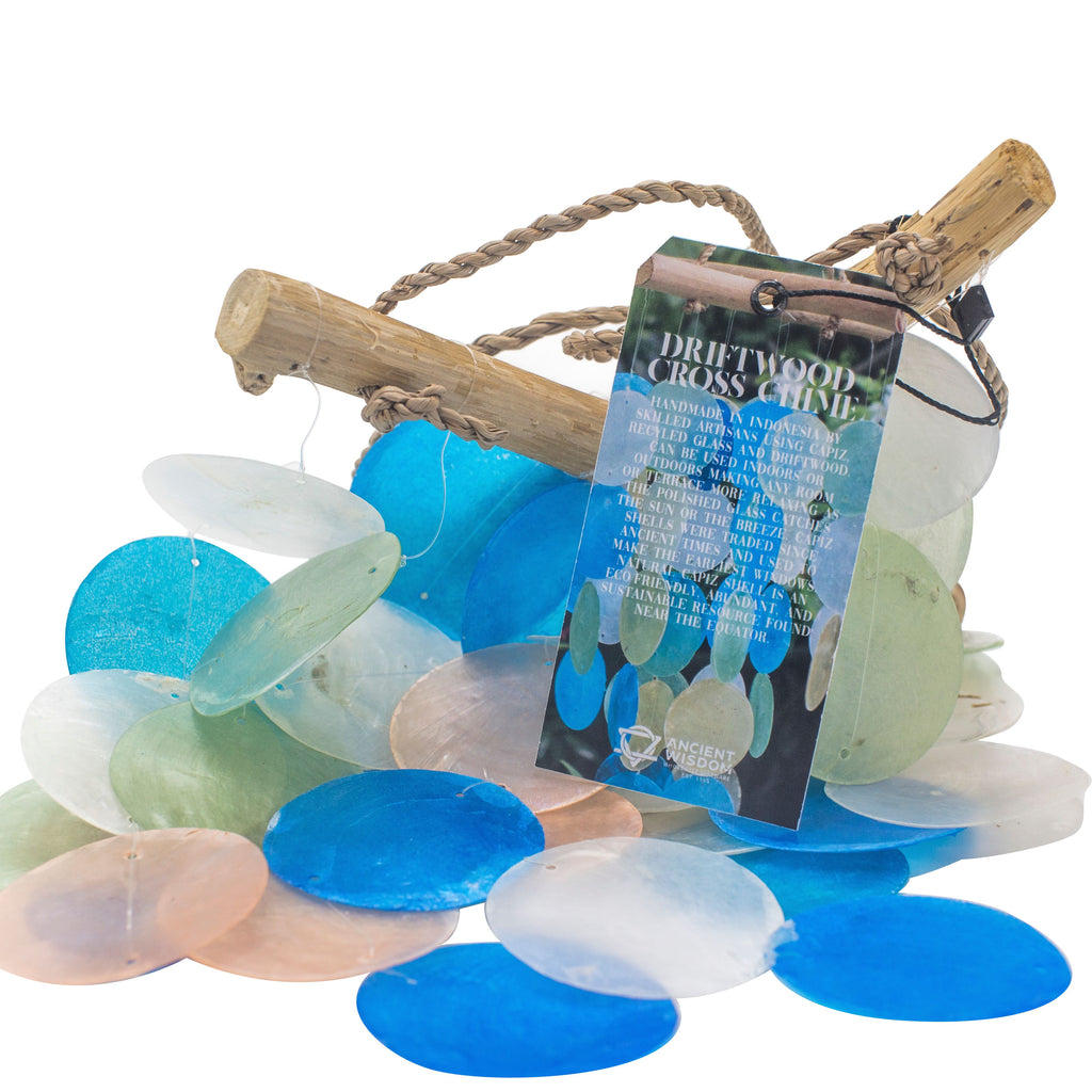 Colorful sea glass pieces with a driftwood cross and tag on a white background