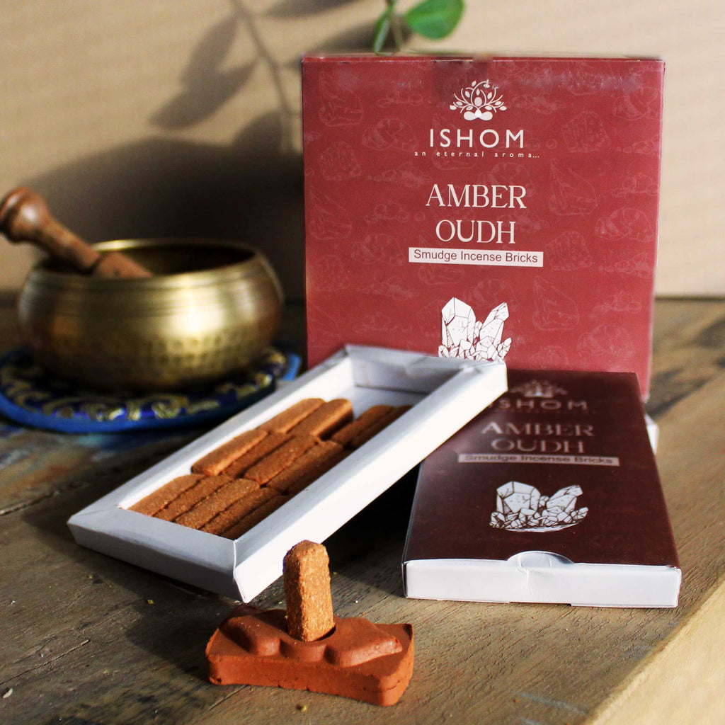 Ishom Amber Oudh incense sticks with packaging on a wooden surface