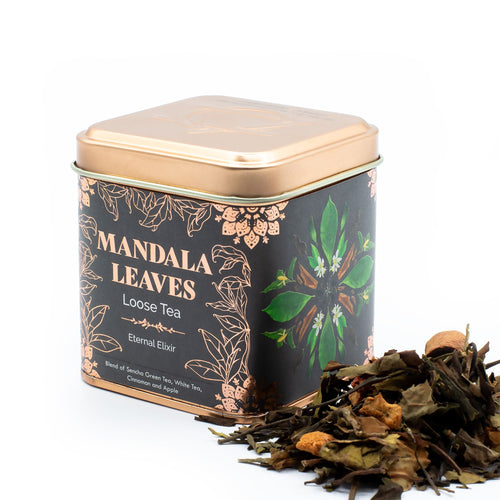 Tea tin labeled 'Mandala Leaves' with loose tea leaves on a white background