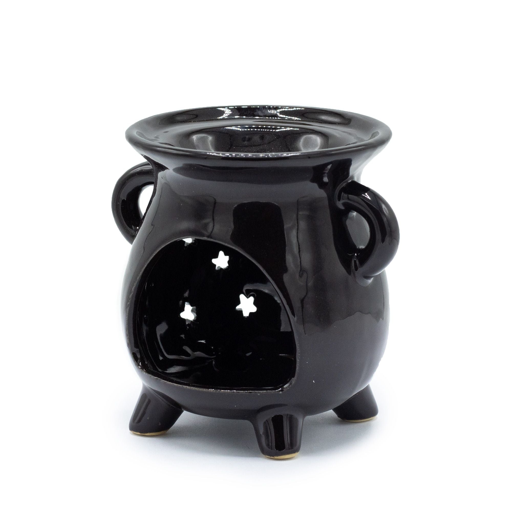 Black ceramic oil burner with star designs on a white background